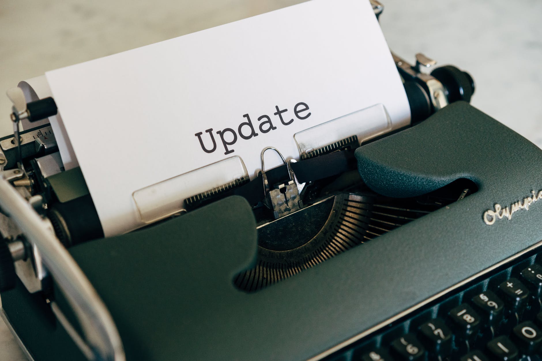 Typewriter with paper that says "Update." Photo by Markus Winkler on Pexels.com.